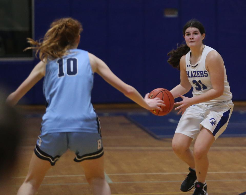 Millbrook's Lydia Kascsak looks to pass away from Pine Plains' Tessa Blackburn during the Section 9 Class C girls basketball championship on February 28, 2024.