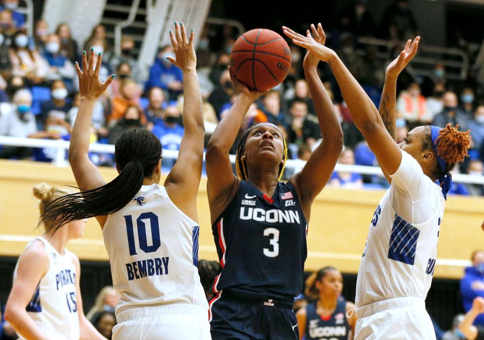 Connecticut forward Aaliyah Edwards (3) goes to the basket against Seton Hall forwards Mya Bembry (10) and Ariel Cummings, right, during the Huskies'  win in South Orange, N.J.