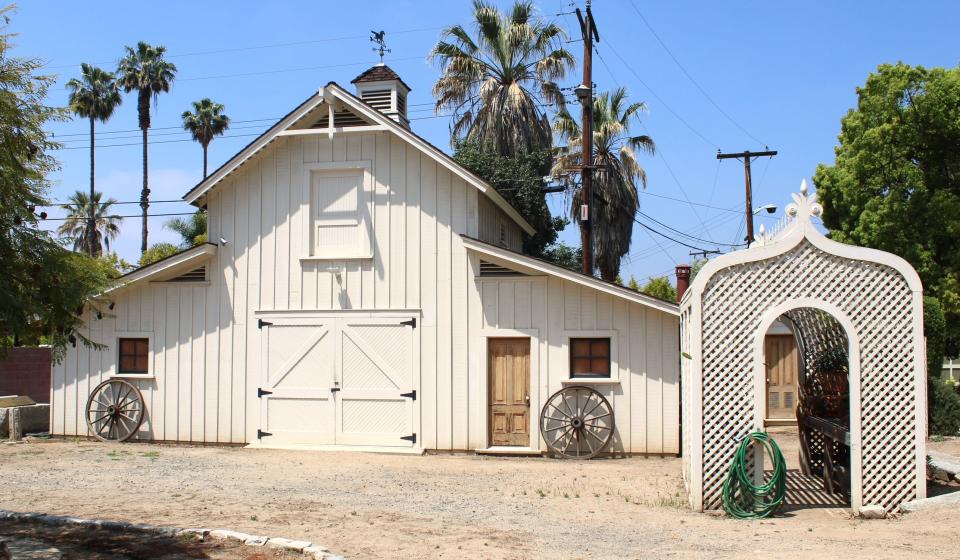 Barn and covered plant arbor just west of the main residence, as seen on April 20, 2024.