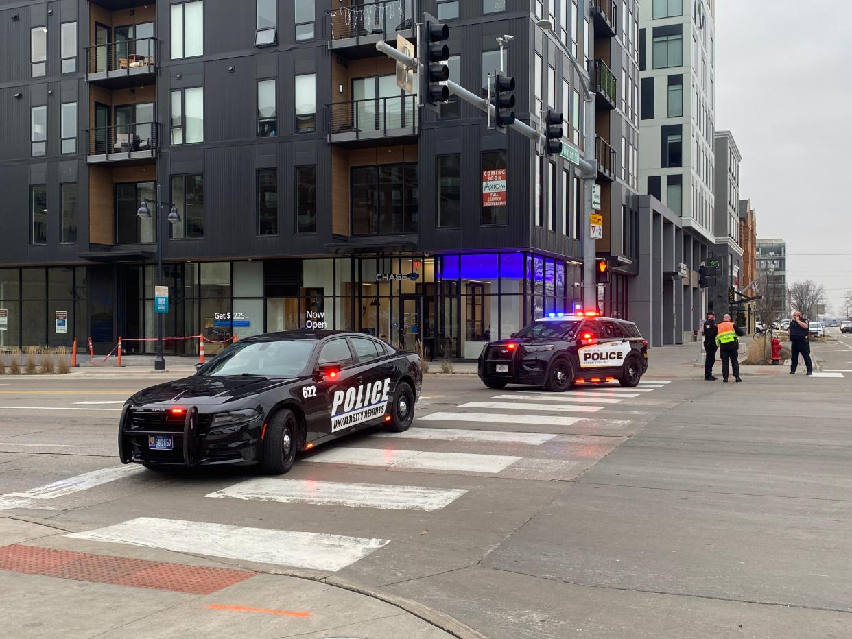University Heights Police and University of Iowa Police squad cars block traffic on East Burlington Street at 2:46 p.m. while law enforcement responded to a hostage situation in a parking ramp and bus depot on Court Street in Iowa City on Dec. 12, 2022.
