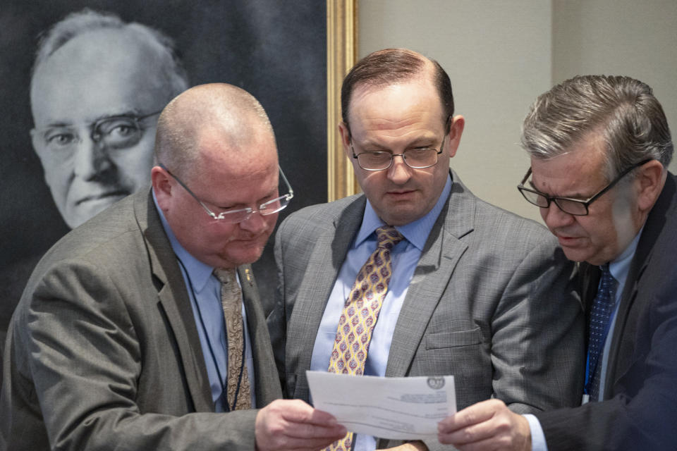 From left, South Carolina Law Enforcement Division special agent David Owen, attorney general Alan Wilson and prosecutor John Meadors look over notes during Alex Murdaugh's double murder trial at the Colleton County Courthouse on Tuesday, Feb. 7, 2023, in Walterboro, S.C. The 54-year-old attorney is standing trial on two counts of murder in the shootings of his wife and son at their Colleton County home and hunting lodge on June 7, 2021. (Andrew J. Whitaker/The Post And Courier via AP, Pool)