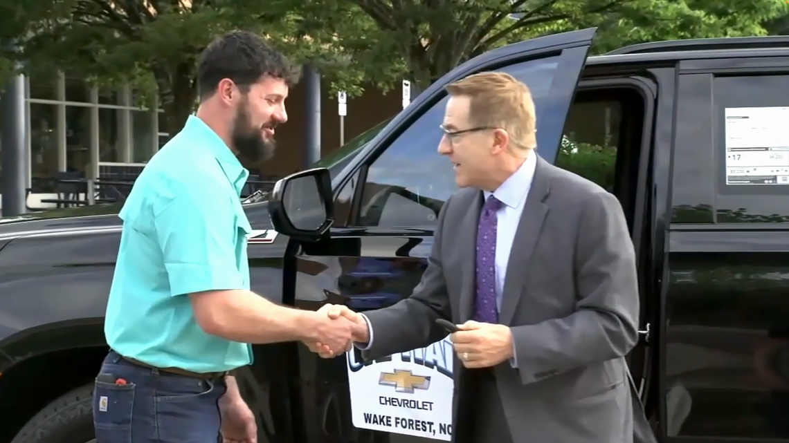 Ryan Berglund, left, a Sustainable Agriculture Academy teacher at Millbrook High School, is WCPSS school district’s 2024 Teacher of the Year. In addition to a $1,000 check, he’ll also get use of a 2024 Chevrolet Tahoe, compliments of Capital Chevrolet, for the next year. ABC11