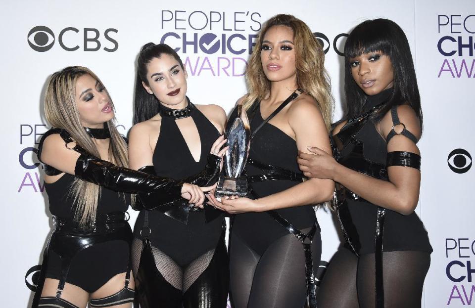 Ally Brooke, from left, Lauren Jauregui, Dinah Jane, and Normani Hamilton of the musical group Fifth Harmony pose in the press room with the award for favorite group at the People's Choice Awards at the Microsoft Theater on Wednesday, Jan. 18, 2017, in Los Angeles. (Photo by Jordan Strauss/Invision/AP)