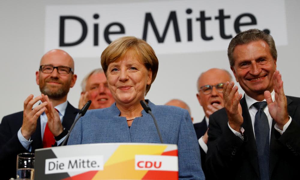 Angela Merkel reacts to the exit polls that suggest she has won a fourth term as chancellor.