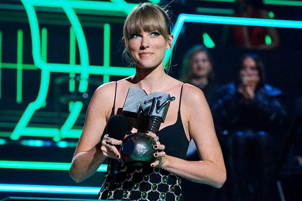 <p>Jeff Kravitz/FilmMagic</p> Taylor Swift accepts an award onstage during the MTV Europe Music Awards 2022 held at PSD Bank Dome on November 13, 2022 in Duesseldorf, Germany. 