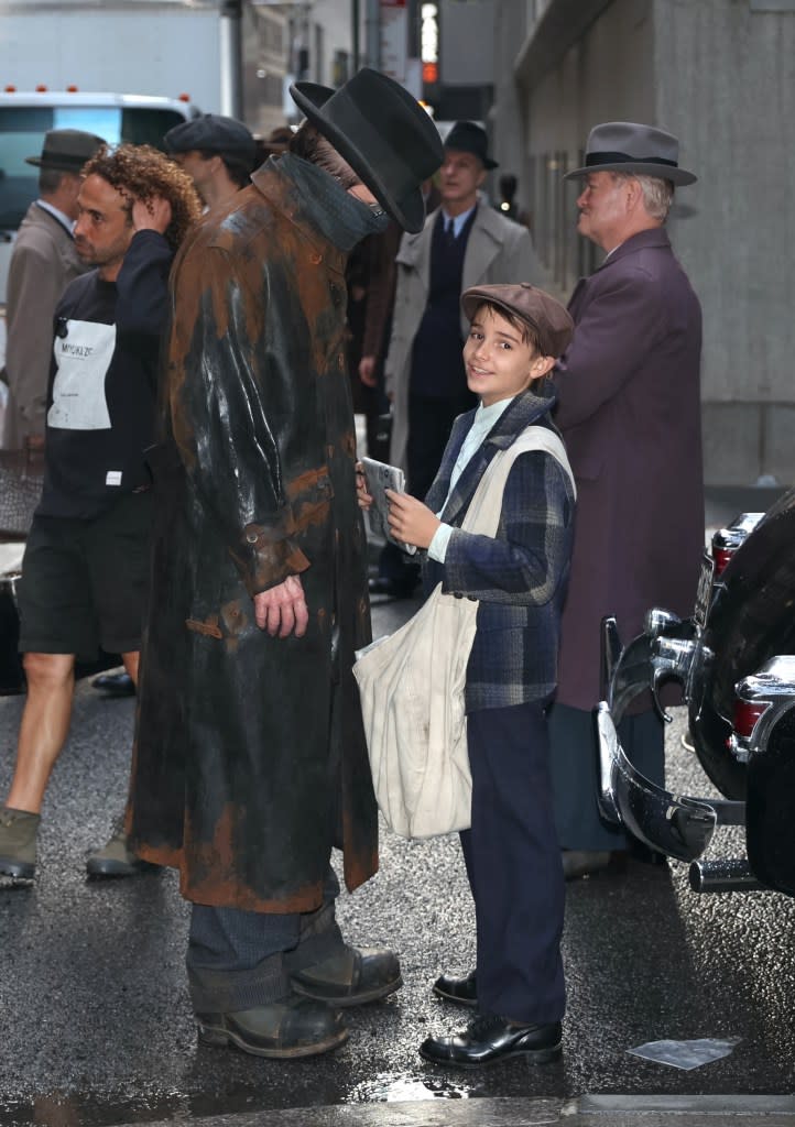 Christian Bale on set with his son, who seems to be an extra. GC Images