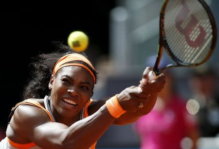 Serena Williams of the U.S. returns the ball to Victoria Azarenka of Belarus during their match at the Madrid Open tennis tournament in Madrid, Spain, May 6, 2015. REUTERS/Susana Vera