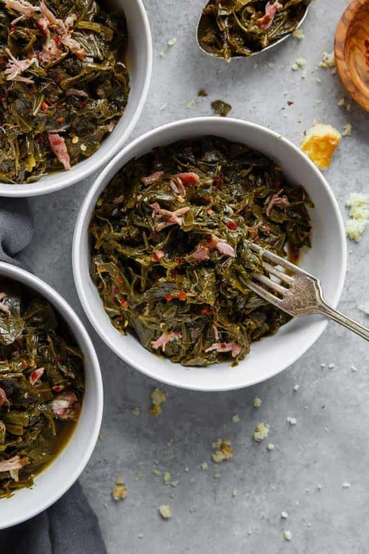 <p>Grandbaby Cakes</p><p>These authentic Southern Collard Greens are braised in savory meat flavored and perfectly spiced pot liquor resulting in an amazing tender silky texture!</p><p><strong>Get the Recipe:</strong><a href="https://grandbaby-cakes.com/collard-greens-recipe/" rel="nofollow noopener" target="_blank" data-ylk="slk:Collard Greens Recipe;elm:context_link;itc:0;sec:content-canvas" class="link rapid-noclick-resp"> <strong>Collard Greens Recipe</strong></a></p>