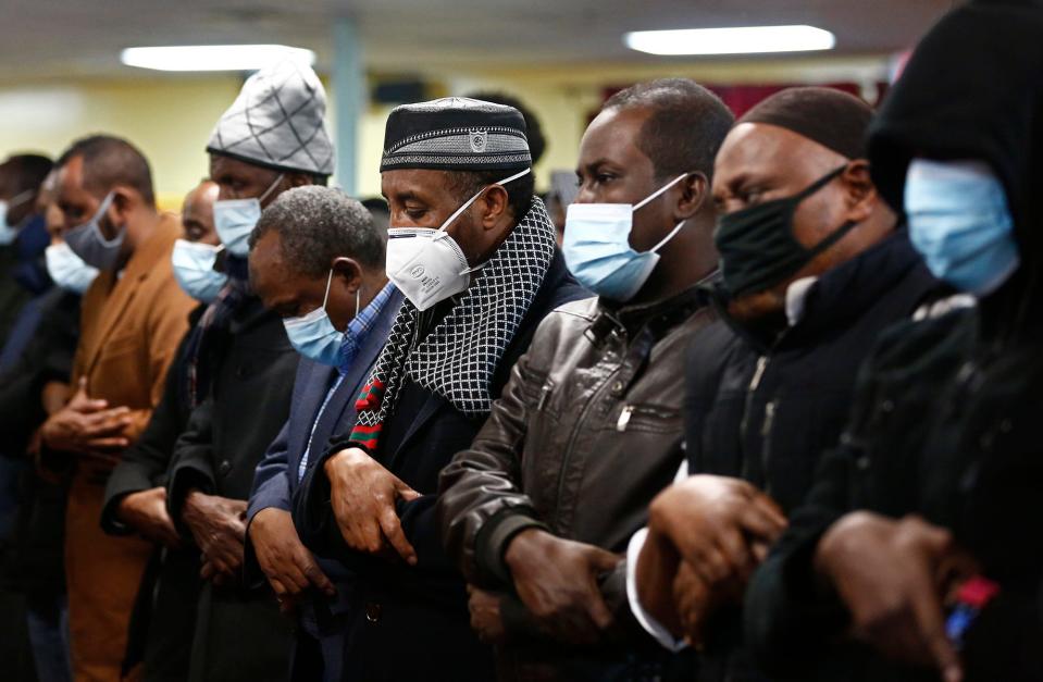 Mourners pray during a memorial service Dec. 30 for slain Imam Mohamed Hassan Adam held at IbnuTaymiyah Masjid and Islamic Center in Columbus.