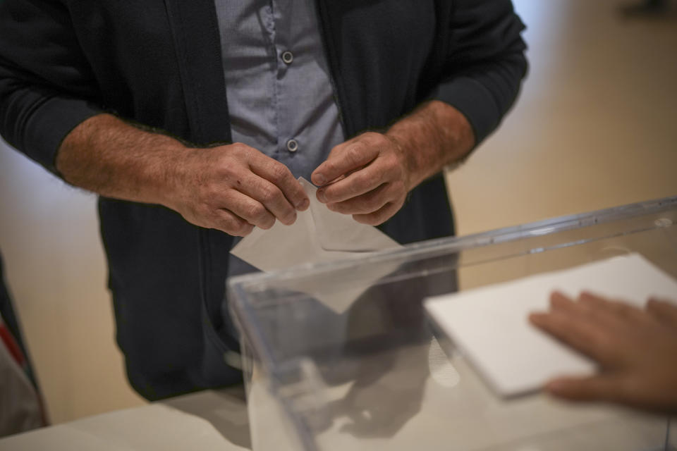 A voter prepares to cast his ballot for Catalonia's regional elections in La Roca del Vallès, north of Barcelona, Sunday May 12, 2024. About 6 million Catalans are casting ballots in a regional election that will test if Catalonia wants pro-independence leader Carles Puigdemont back or if the wealthy region has moved on to more pressing worries.(AP Photo/Emilio Morenatti)