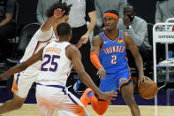 Oklahoma City Thunder guard Shai Gilgeous-Alexander (2) drives as Phoenix Suns forward Mikal Bridges (25) defends during the first half of an NBA basketball game, Wednesday, Jan. 27, 2021, in Phoenix. (AP Photo/Matt York)