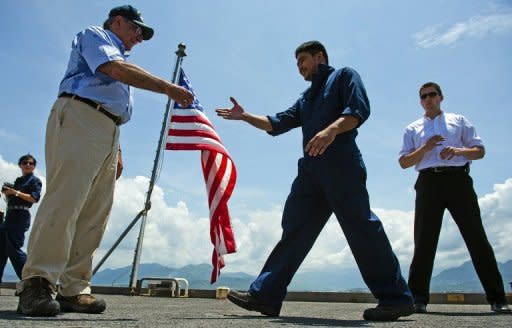 US Secretary of Defense Leon Panetta (L) hands out coins to members of the crew as he visits the USNS Richard E. Byrd docked in Vietnam's Cam Ranh Bay on June 3. Panetta became the first Pentagon chief to visit southern Cam Ranh Bay since the end of the Vietnam War