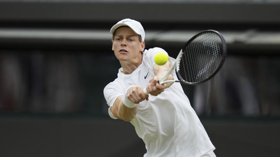 Jannik Sinner of Italy plays a backhand return to Ben Shelton of the United States during their fourth round match at the Wimbledon tennis championships in London, Sunday, July 7, 2024. (AP Photo/Kirsty Wigglesworth)