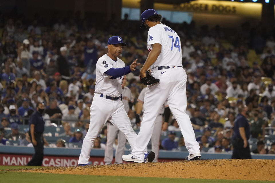 Los Angeles Dodgers relief pitcher Kenley Jansen (74) is removed by manager Dave Roberts during the ninth inning of the team's baseball game against the San Francisco Giants on Wednesday, July 21, 2021, in Los Angeles. (AP Photo/Marcio Jose Sanchez)