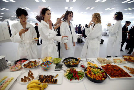 Models eat food backstage before Christian Dior's Haute Couture Spring-Summer 2017 live show to celebrate Dior's new flagship store at the Ginza Six mall in Tokyo, Japan, April 19, 2017. REUTERS/Toru Hanai