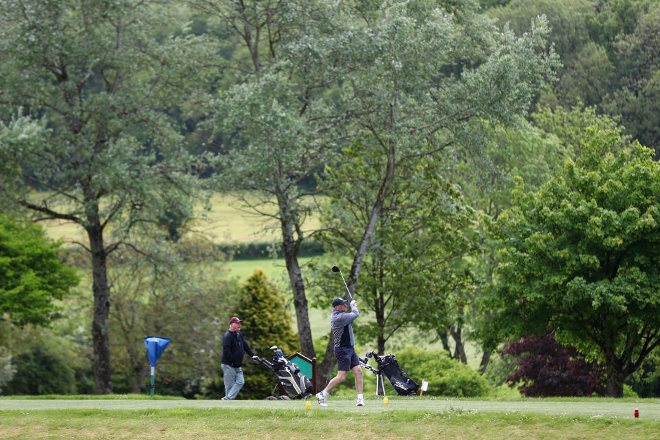 A golfer tees off at Wells Golf Club in Somerset.