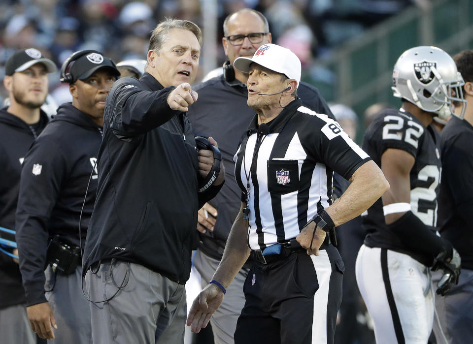 Oakland Raiders head coach Jack Del Rio speaks with referee Ed Hochuli during a game last season. (AP)