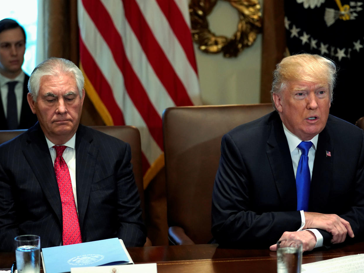 Mr Tillerson pictured seated beside Mr Trump at the White house: Reuters