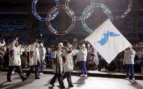 2006: Korean flag-bearers carry a unification flag during the Winter Olympics opening ceremony in Turin, Italy - Credit: AP Photo/Amy Sancetta