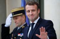 French President Emmanuel Macron and NATO Secretary General Jens Stoltenberg leave after a meeting at the Elysee Palace in Paris