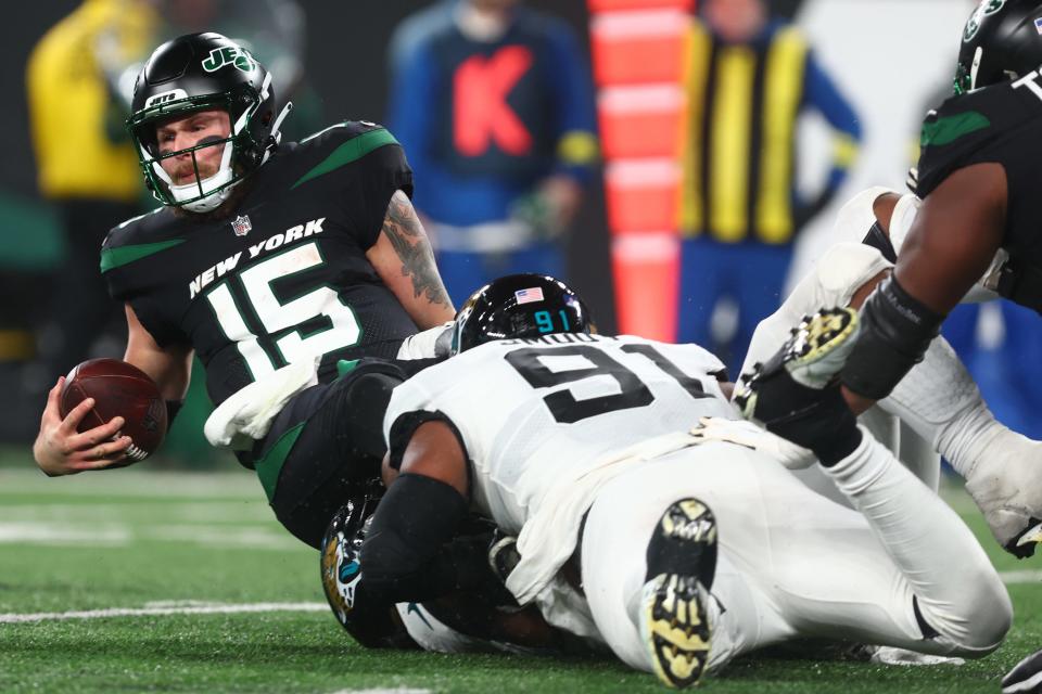 Dec 22, 2022; East Rutherford, New Jersey, USA; New York Jets quarterback Chris Streveler (15) is sacked by Jacksonville Jaguars defensive end Dawuane Smoot (91) during the second half at MetLife Stadium. Mandatory Credit: Ed Mulholland-USA TODAY Sports