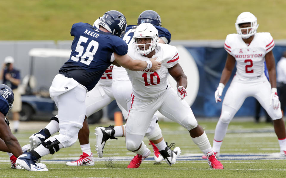 Houston Cougars defensive tackle Ed Oliver (10) works to get around Rice Owls offensive lineman Shea Baker (58) during a NCAA college football game against the Rice Owls Saturday, Sep. 1, 2018, in Houston. (AP Photo/Michael Wyke)