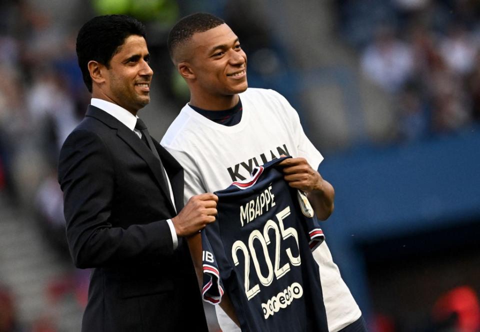 Kylian Mbappe with PSG president Nasser Al-Khelaifi after signing his new contract   (AFP via Getty Images)