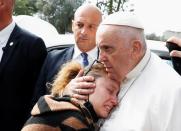 Pope Francis waves from a car as he leaves Rome's Gemelli hospital in Rome