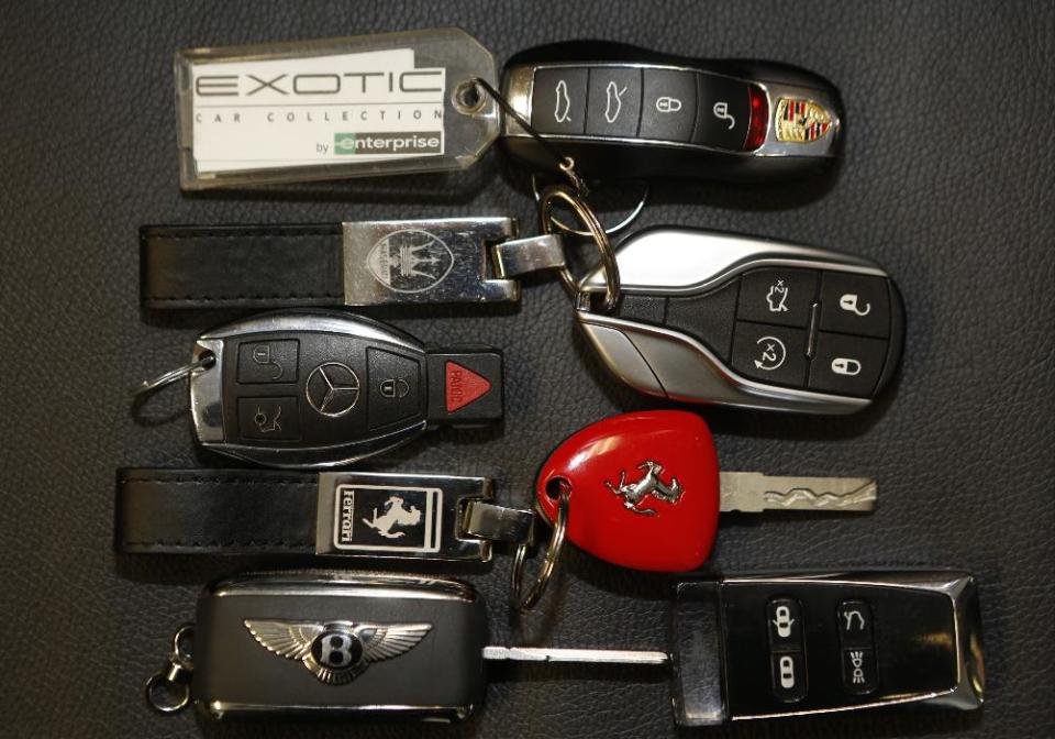 In this Wednesday, March, 26, 2014 photo, luxury car keys for Porsche, Maserati, Jaguar, Mercedes-Benz, Ferrari, Bentley Continental, and Aston Martin are displayed at the Enterprise Exotic Car Collection showroom near Los Angeles International Airport. (AP Photo/Damian Dovarganes)