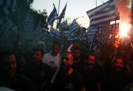 Far-right protesters take part in a rally during the annual state of the economy speech by Greece's Prime Minister Kyriakos Mitsotakis in the northern city of Thessaloniki, Greece, Saturday, Sept. 12, 2020. Mitsotakis outlined plans Saturday to upgrade the country's defense capabilities, including purchases of new fighter planes, frigates, helicopters and weapons systems, amid heightened tensions with neighboring Turkey over rights to resources in the eastern Mediterranean. (InTime News via AP)