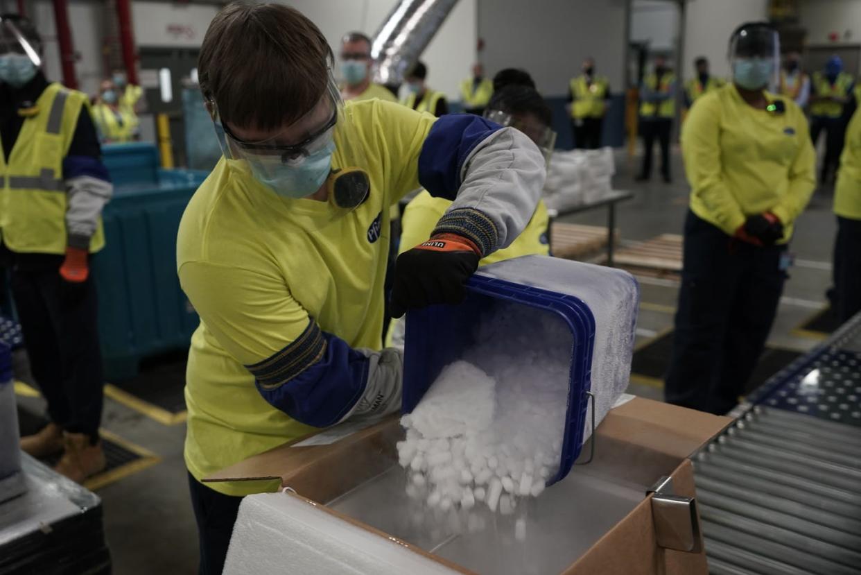 <span class="caption">A worker pours dry ice into boxes containing Pfizer's COVID-19 vaccine.</span> <span class="attribution"><a class="link " href="https://www.gettyimages.com/detail/news-photo/worker-pours-dry-ice-into-boxes-containing-the-pfizer-news-photo/1230102477?adppopup=true" rel="nofollow noopener" target="_blank" data-ylk="slk:Morry Gash/Pool/AFP via Getty Images;elm:context_link;itc:0;sec:content-canvas">Morry Gash/Pool/AFP via Getty Images</a></span>