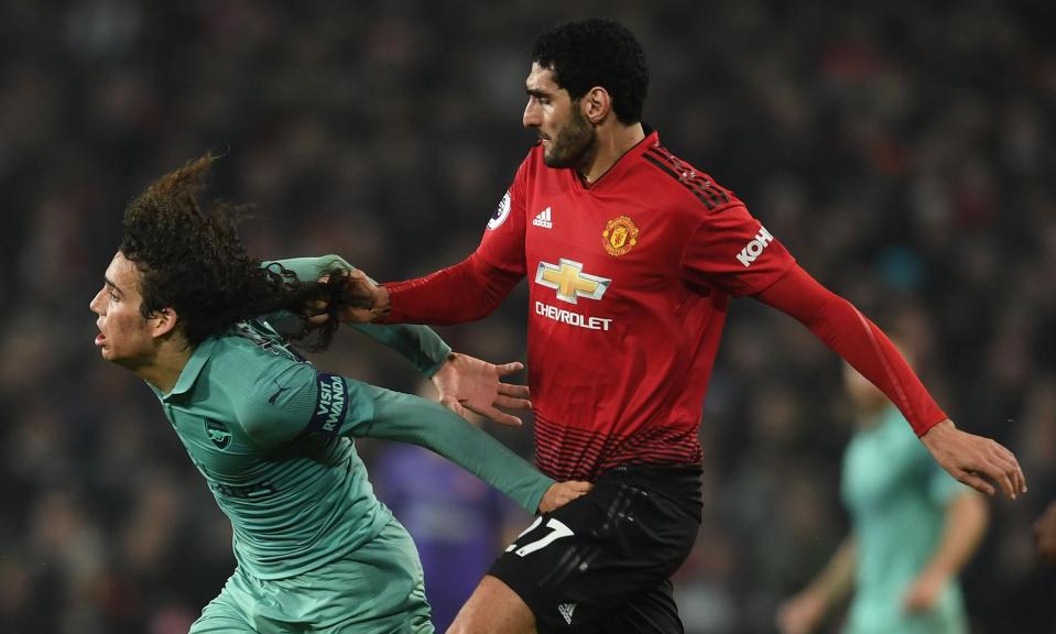 Arsenal’s Mattéo Guendouzi has his hair pulled by Marouane Fellaini at Manchester United.