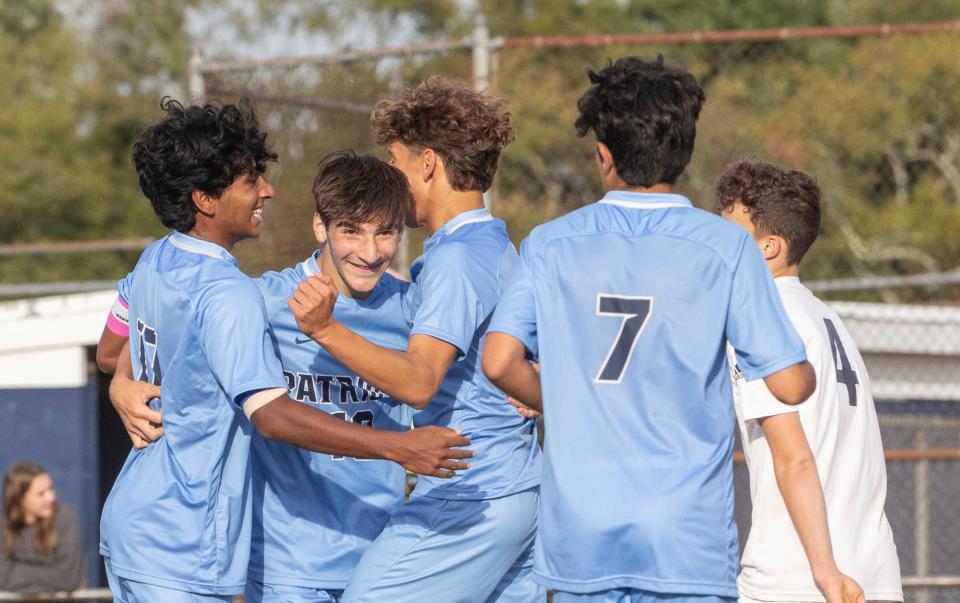 Freehold Kevin Kuriakose (on left) celebrates with teammates after scoring his team’s first goal. Freehold Township Boys Soccer defeats Marlboro 2-0 in Freehold Township on September  29, 2022. 