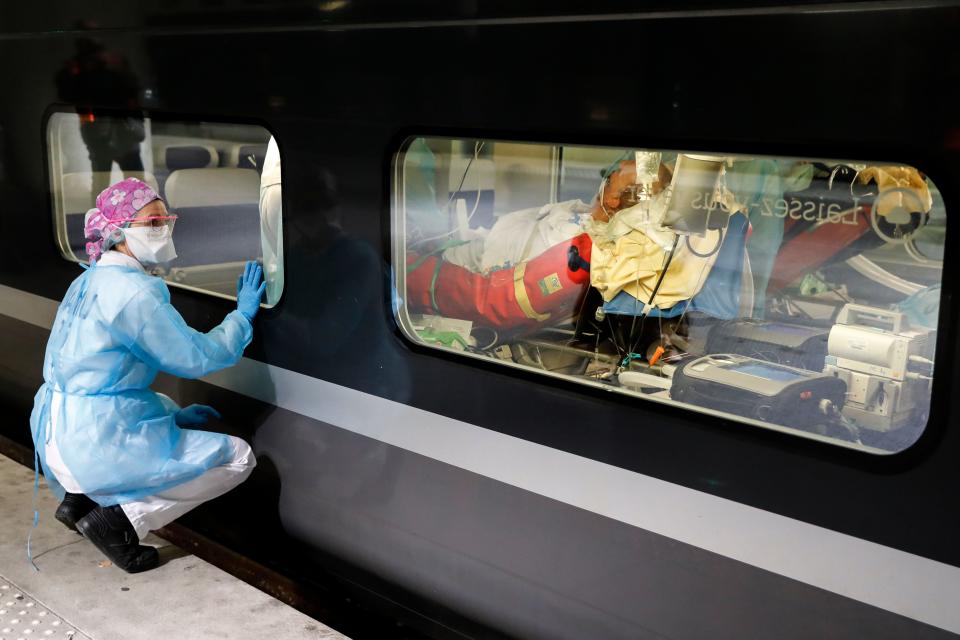 PARIS, FRANCE, April 2: A medical worker watches from a platform of the Gare d'Austerlitz train station as patients infected with the COVID-19 are transferred to  hospitals in the western France Brittany region where the outbreak has so far been limited. (Photo by Thomas Samson / various sources / AFP) 