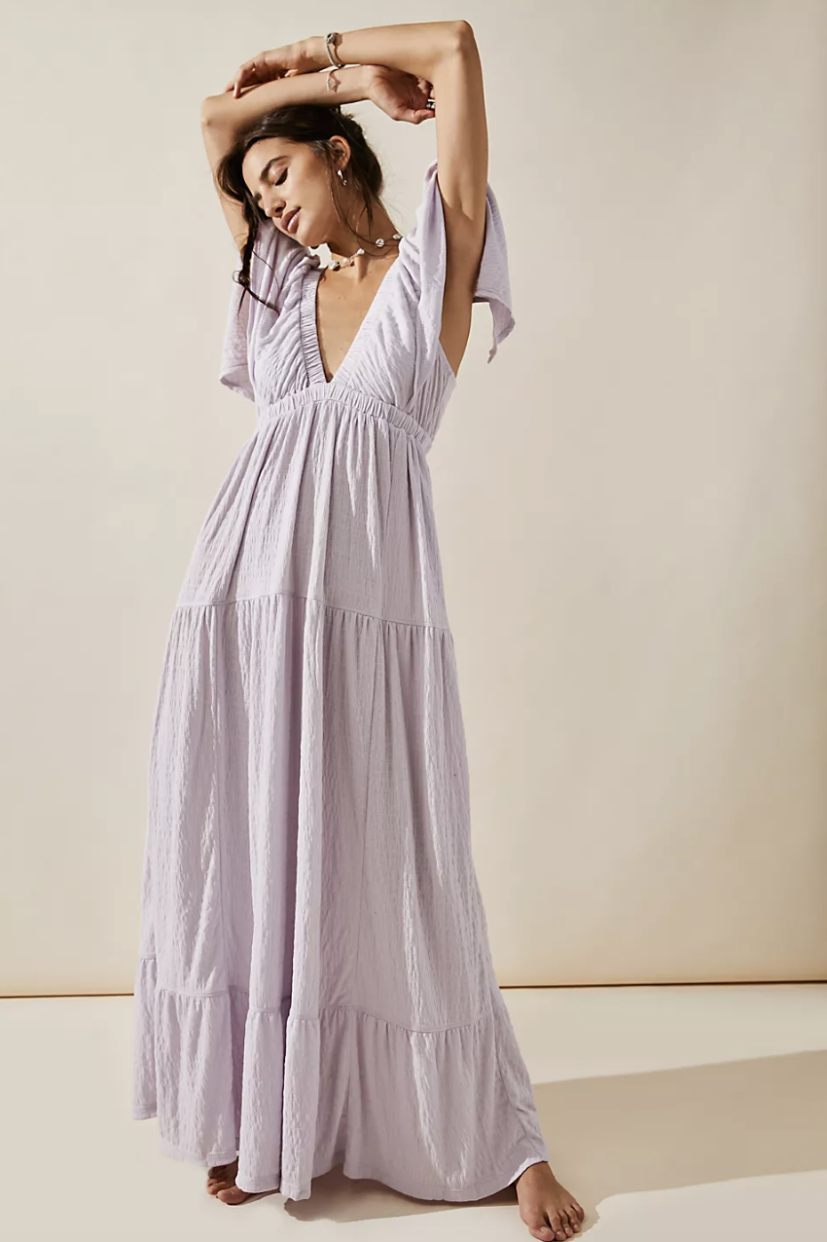 brunette model wearing light purple La La Maxi Dress with sleeves (Photo via Free People)