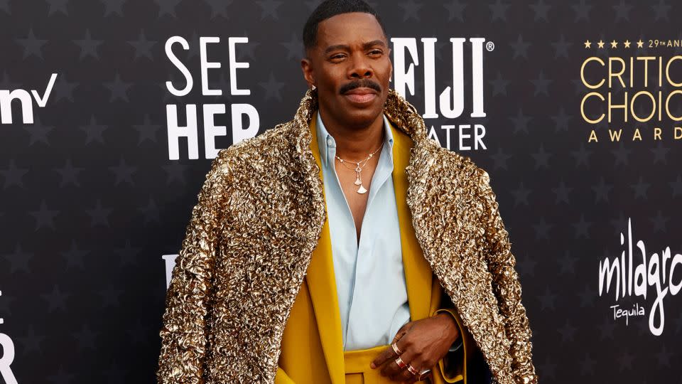 Colman Domingo, nominated for his performance in "Rustin," wore a custom Valentino outfit featuring a mustard suit with a golden overcoat and matching shoes. “I have a sense of play,” he said during the red carpet preshow. “I’m not always playing dark characters.” - Michael Tran/AFP/Getty Images