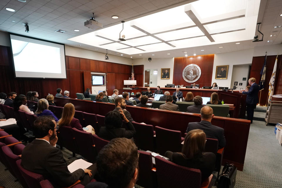 Joseph Reid, of McGuireWoods, representing Dominion, right, speaks as commissioners, Jehmal Hudson, top left, and Judith Williams Jagdmann, top center, listen during a meeting of the State Corporations Commission Tuesday May 17, 2022, in Richmond, Va. The commission was reviewing an application for Dominion's offshore wind project. (AP Photo/Steve Helber)