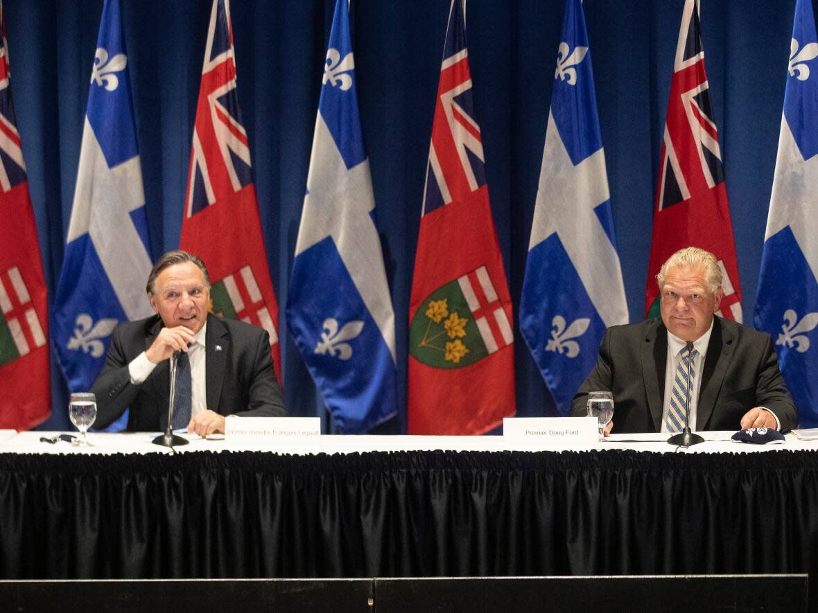 During the Quebec election campaign, Premier François Legault, left, said his province needed to increase hydroelectricity production. (Chris Young/The Canadian Press - image credit)