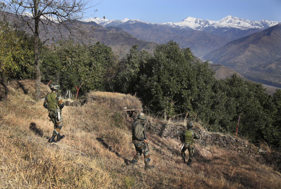 Indian army soldiers patrol near a forward post at the Line of Control (LOC) that divides the region between the two nuclear-armed rivals of India and Pakistan, in Poonch, about 248 kilometers (155 miles) from Jammu, India, Wednesday, Dec. 16, 2020. Tens of thousands of soldiers from India and Pakistan are positioned along the two sides. The apparent calm is often broken by the boom of blazing guns, with each side accusing the other of initiating the firing. (AP Photo/Channi Anand)