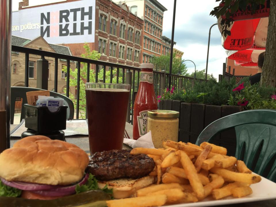 The patio at the Vermont Pub & Brewery has views of College Street (and of its Burly Irish Ale and burger and fries).