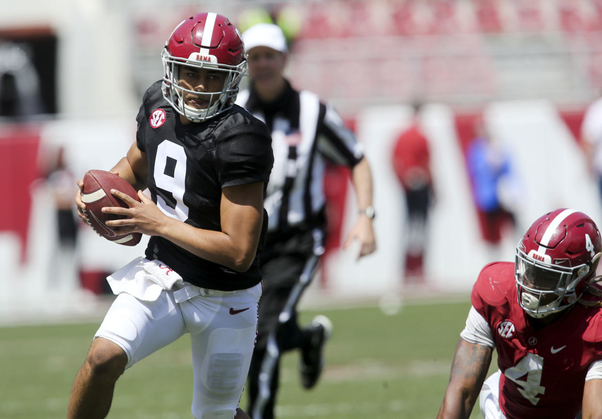 Apr 17, 2021; Tuscaloosa, Alabama, USA; White quarterback Bryce Young (9) scrambles for a first down after moving away from Crimson linebacker Christopher Allen (4) during the Alabama A-Day game at Bryant-Denny Stadium. Mandatory Credit: Gary Cosby-USA TODAY Sports