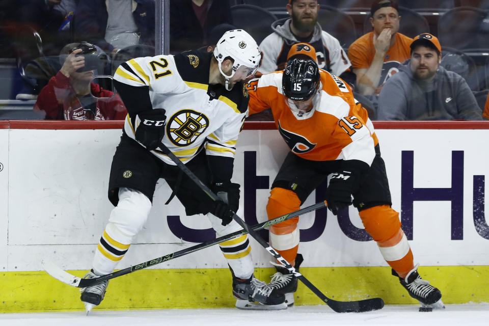Boston Bruins' Nick Ritchie, left, and Philadelphia Flyers' Matt Niskanen battle for the puck during the second period of an NHL hockey game, Tuesday, March 10, 2020, in Philadelphia. (AP Photo/Matt Slocum)