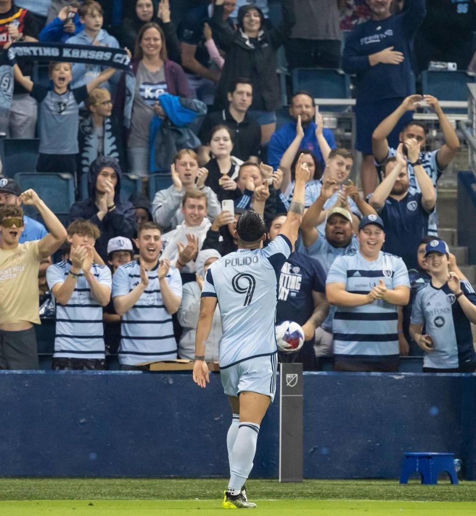 Sporting Kansas City forward Alán Pulido acknowledges the fans after scoring his second goal during Saturday’s match at Children’s Mercy Park in Kansas City, Kansas.