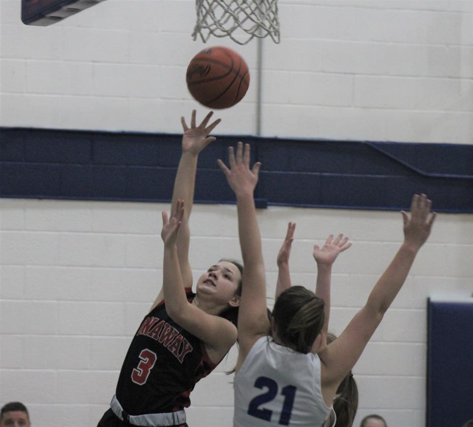 Onaway sophomore Charlotte Box (3) puts up a shot over Mackinaw City senior Julia Sullivan (21) during the second half of Thursday night's non-conference girls basketball clash.