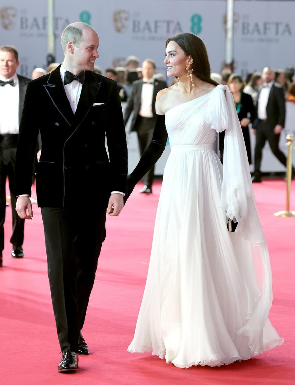 <p>The Prince and Princess of Wales were spotted on the red carpet at the 2023 BAFTA awards on Sunday, February 20 in London. While walking in front of fans and cameras, the Prince was seen whispering something into his wife's ear, before she responded and was seen cheekily tapping his right butt cheek with her gloved hand in a moment captured by one <a href="https://twitter.com/molllyelizabeth/status/1627378442168590336?s=46&t=ybVt9d5-zraRllj8KL5PRA" rel="nofollow noopener" target="_blank" data-ylk="slk:Twitter;elm:context_link;itc:0;sec:content-canvas" class="link ">Twitter</a> user. </p><p>For the occasion, the Prince dressed in a black tuxedo with a box tie, while his wife rewore an updated version of her 2019 BAFTA awards Alexander McQueen dress, this time with black opera gloves. </p>