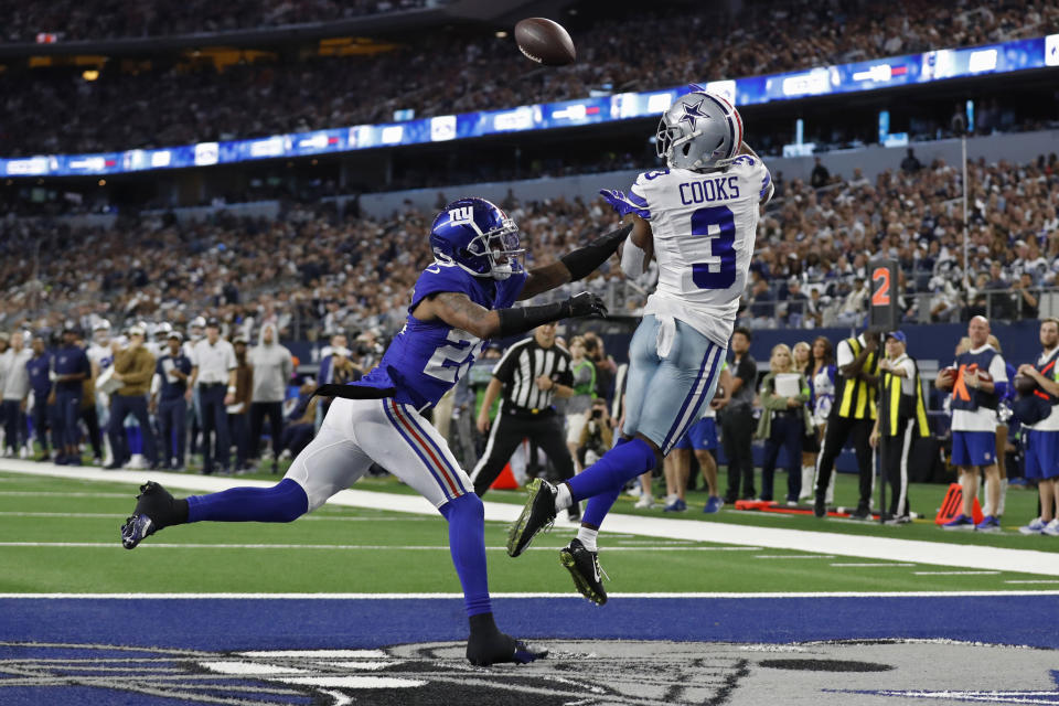 Dallas Cowboys wide receiver Brandin Cooks (3) catches a touchdown pass in front of New York Giants cornerback Cor'Dale Flott, left, in the first half of an NFL football game, Sunday, Nov. 12, 2023, in Arlington, Texas. (AP Photo/Roger Steinman)