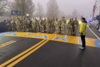 Boston Marathon Race Director Dave McGillivray sends out a group of about 20 from the Massachusetts National Guard, which walks the course annually, announcing the start of the 127th marathon Monday, April 17, 2018. (AP Photo/Jennifer McDermott)