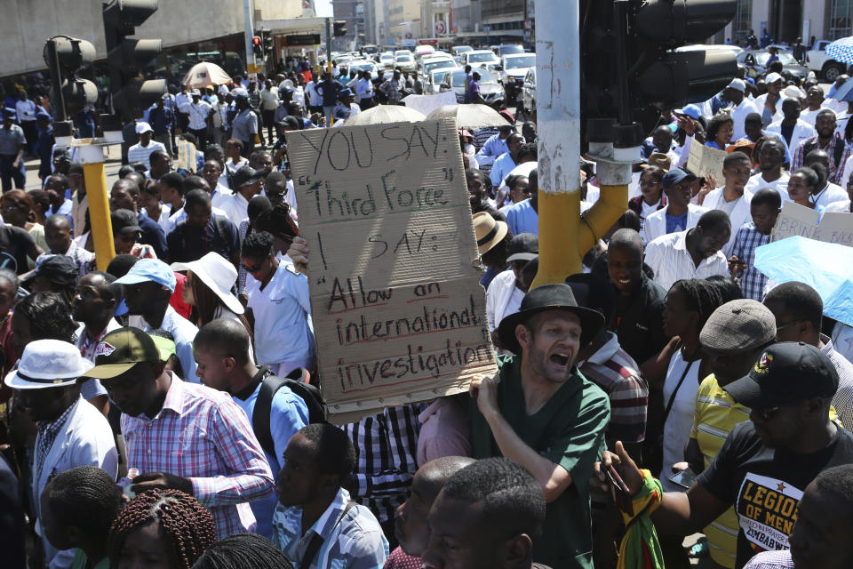 Zimbabewean medical staff march on the streets of Harare, Thursday, Sept. 19, 2019. Zimbabwean doctors protesting the alleged abduction of a union leader won a High court ruling allowing them to march and handover a petition to the parliament.The Zimbabwe Hospital Doctors Association has said its president, Peter Magombeyi, was abducted on Saturday after calling for a pay strike, and members say they will not return to work until he is found. (AP Photo/Tsvangirayi Mukwazhi)