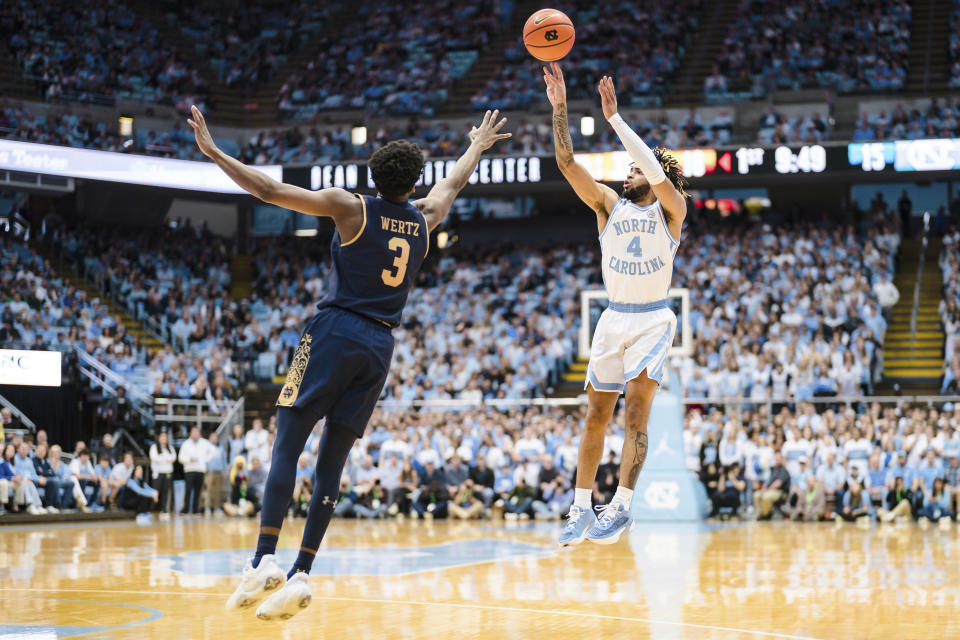 North Carolina guard R.J. Davis (4) shoots over Notre Dame guard Trey Wertz (3) in the first half of an NCAA college basketball game on Saturday, Jan. 7, 2023, in Chapel Hill, N.C. (AP Photo/Jacob Kupferman)