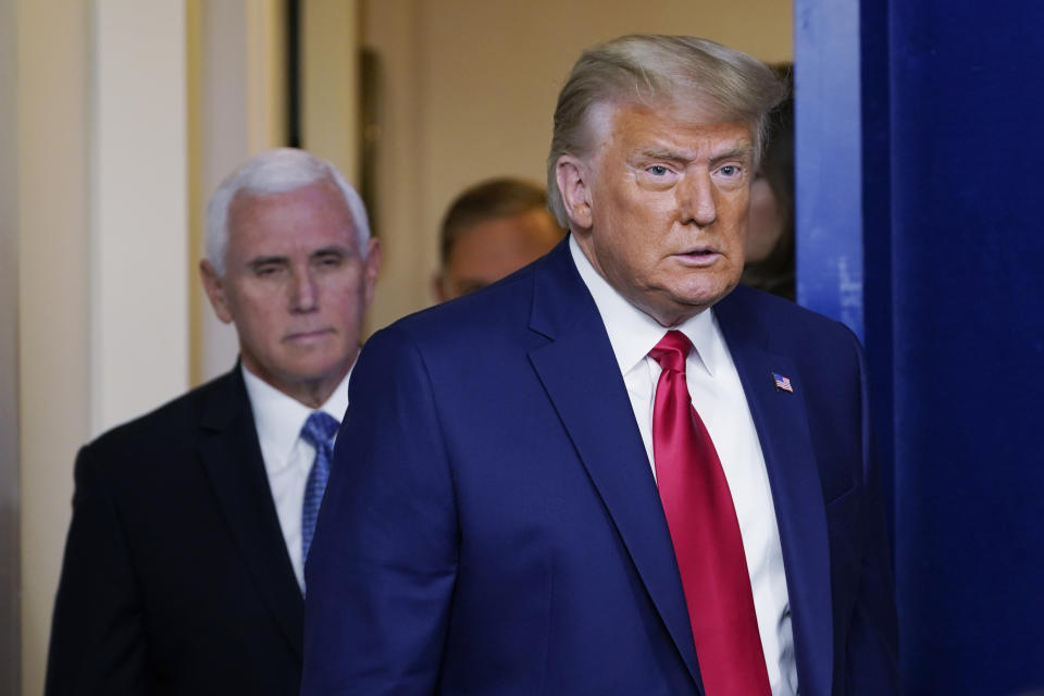 President Donald Trump walking out to speak in the Brady Briefing Room in the White House, Tuesday, Nov. 24, 2020, in Washington. Walking behind Trump is Vice President Mike Pence. (AP Photo/Susan Walsh)